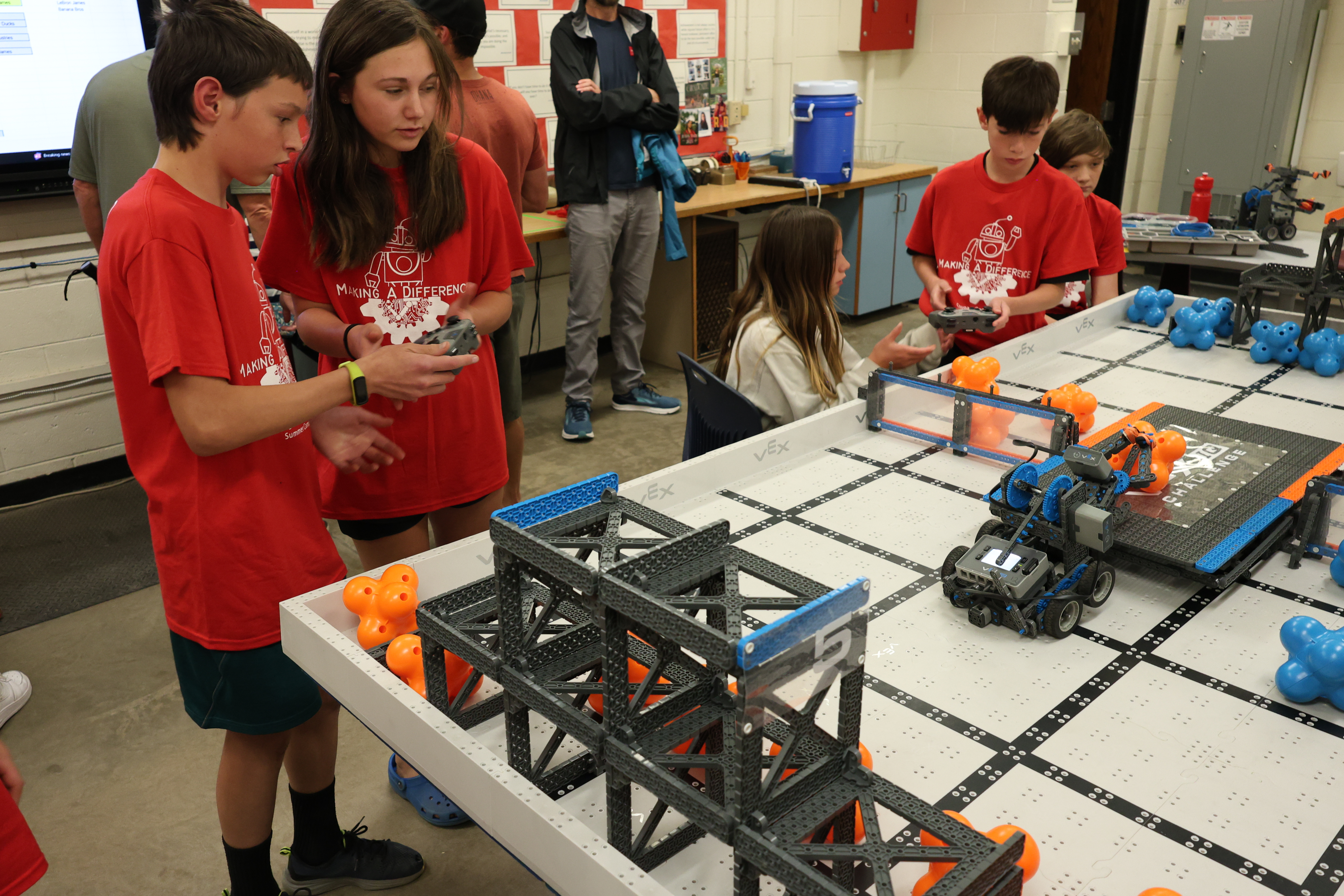 Photo of students driving their Vex IQ robots durring M.A.D. Summer Camp.